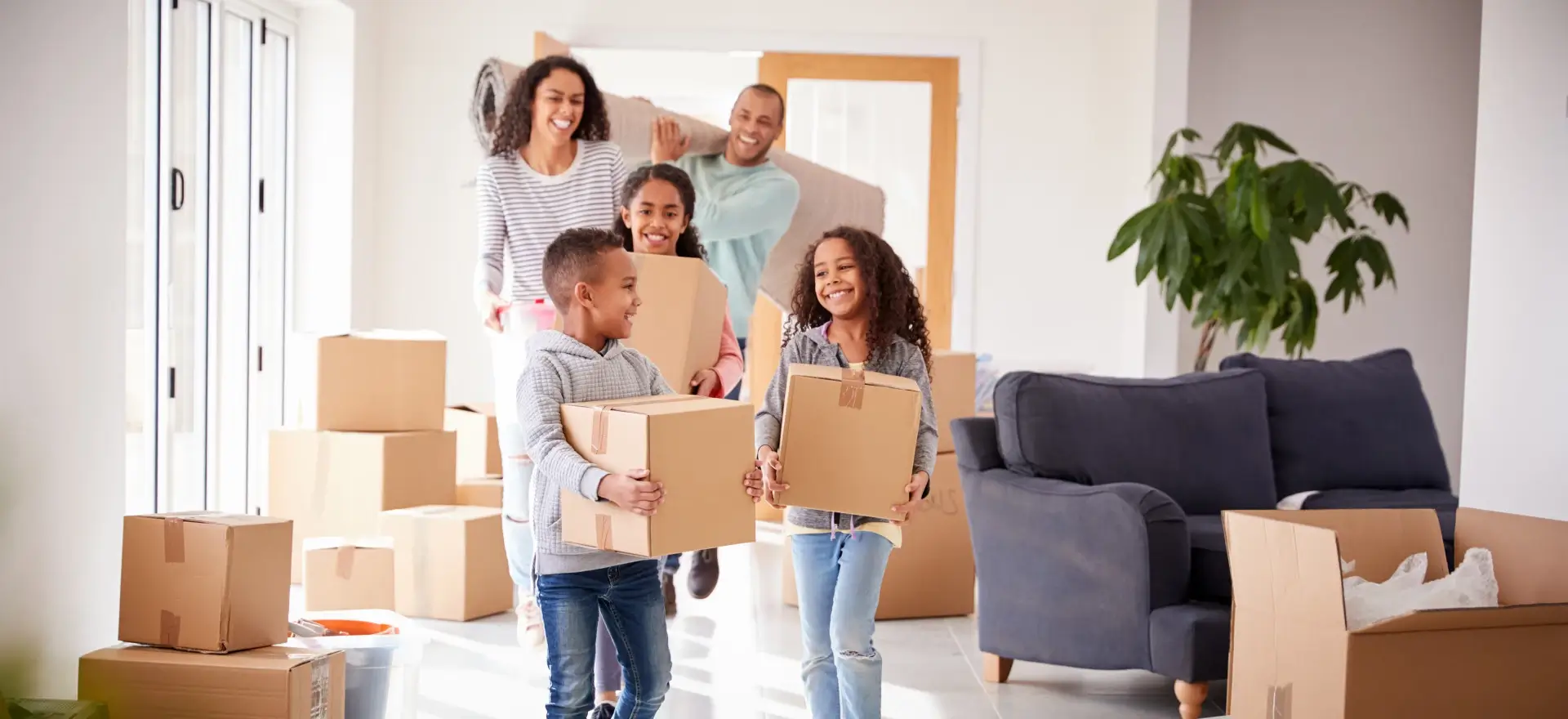 Happy family moving in to their new home thanks to Noreast Mortgage Services